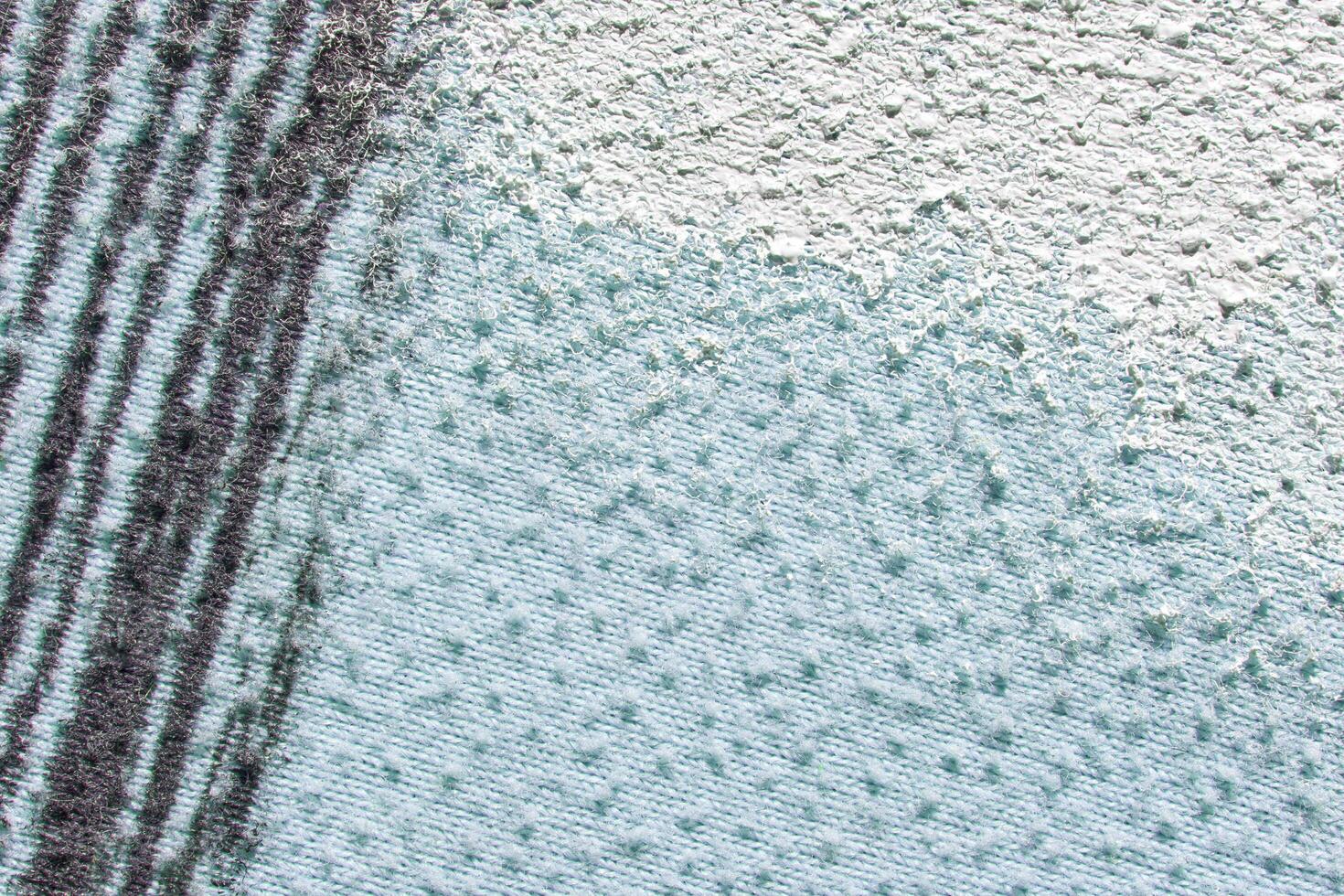 Textured abstract background with variegated white and blue colors featuring vertical black lines. photo