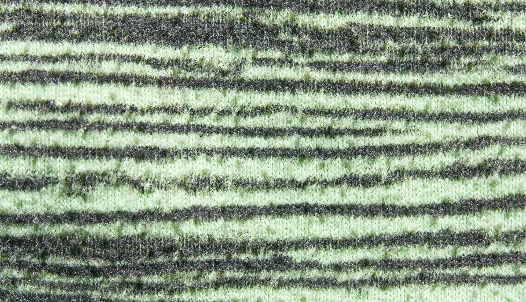 Close up of textured green and black striped fabric surface pattern. photo