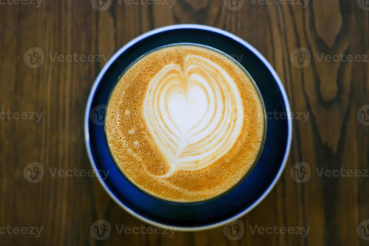 Coffee art in a cup on wooden table photo