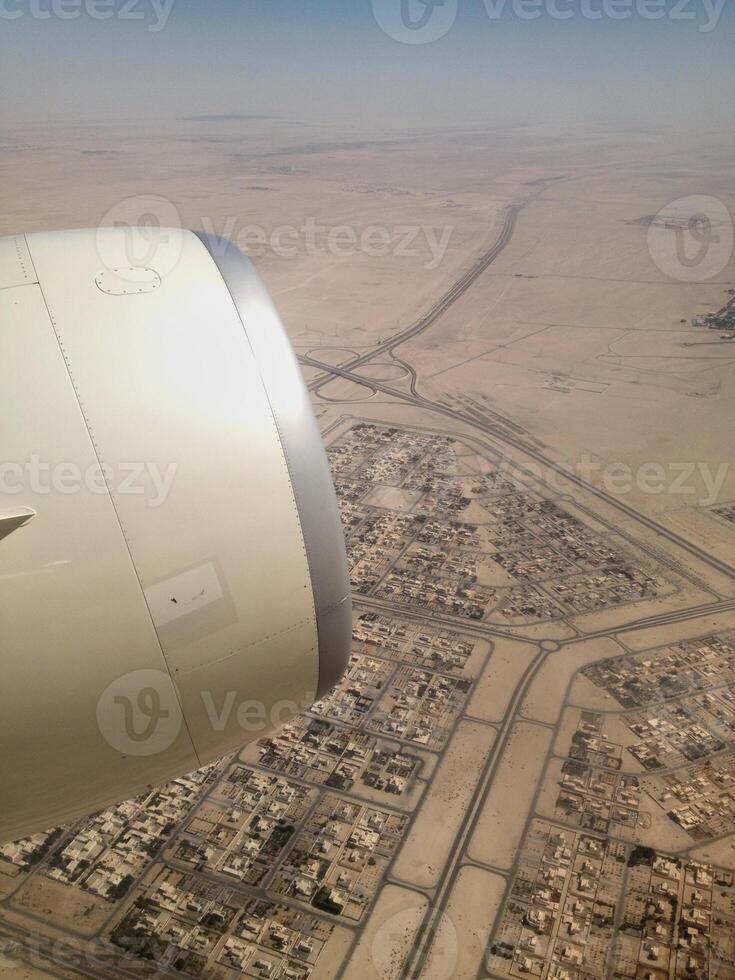 High angle view of desert land and city from airplane photo