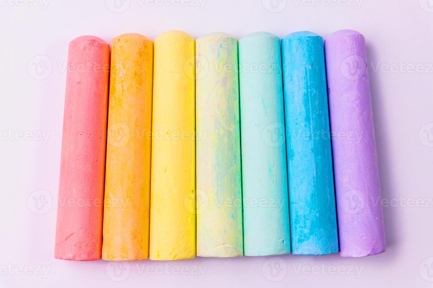 Multi coloured chalk isolated on white background photo