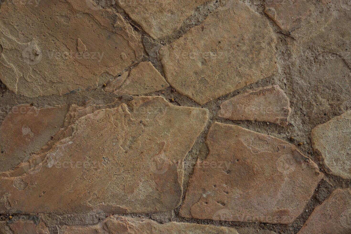 Old and weathered large stone blocks wall, stone texture. photo