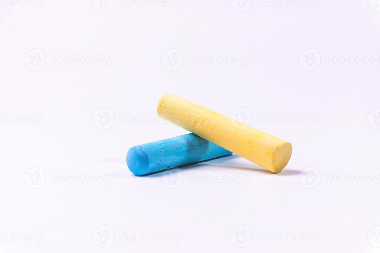 Crayons of different colors arranged on a white background. Education photo