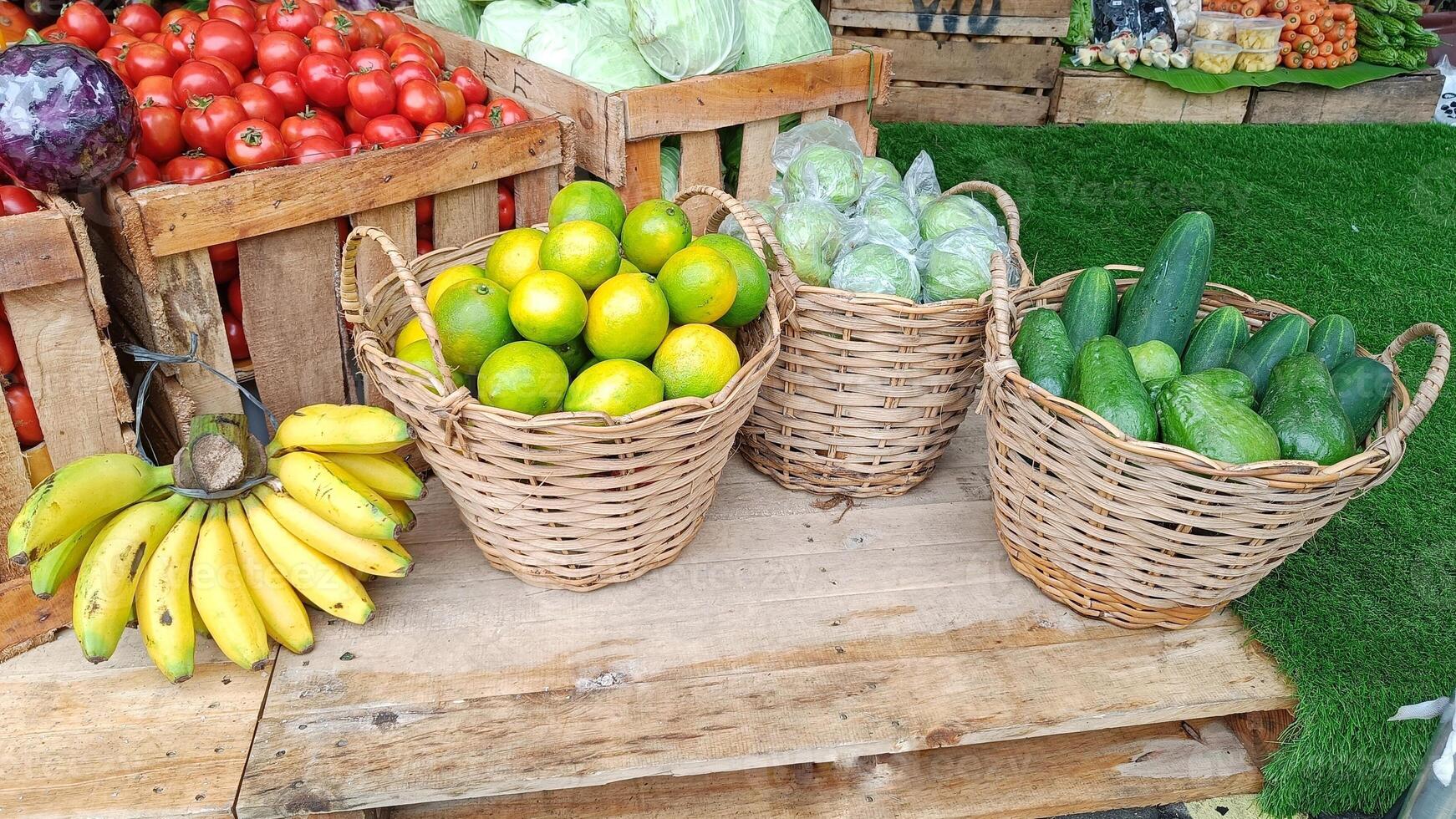 Close Up Banana, Lime and Guava without seeds in basket displayed on wooden board in market photo