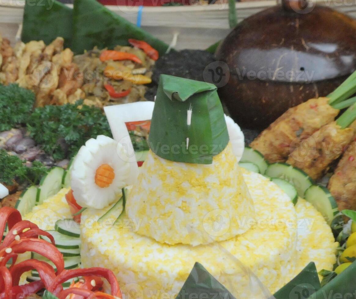 Tumpeng Sego Empog Made from mashed rice and corn and served with side dishes and vegetables photo