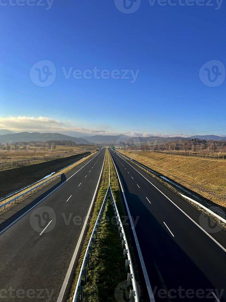 Two-lane road with mountains in the background. Sudetes, Poland photo