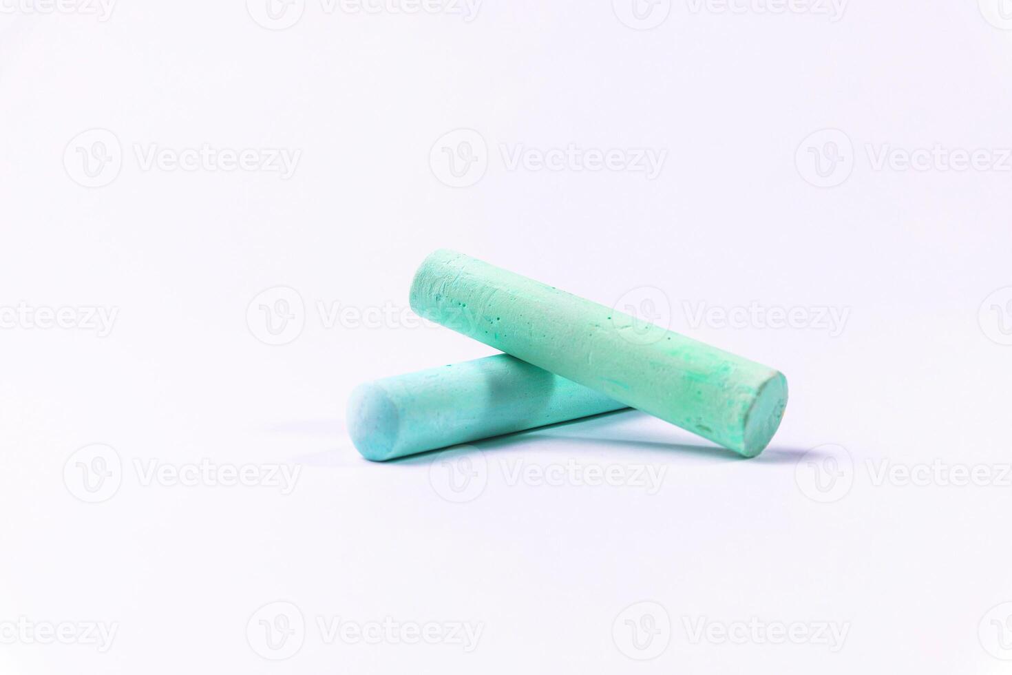 Crayons of different colors arranged on a white background. Education photo