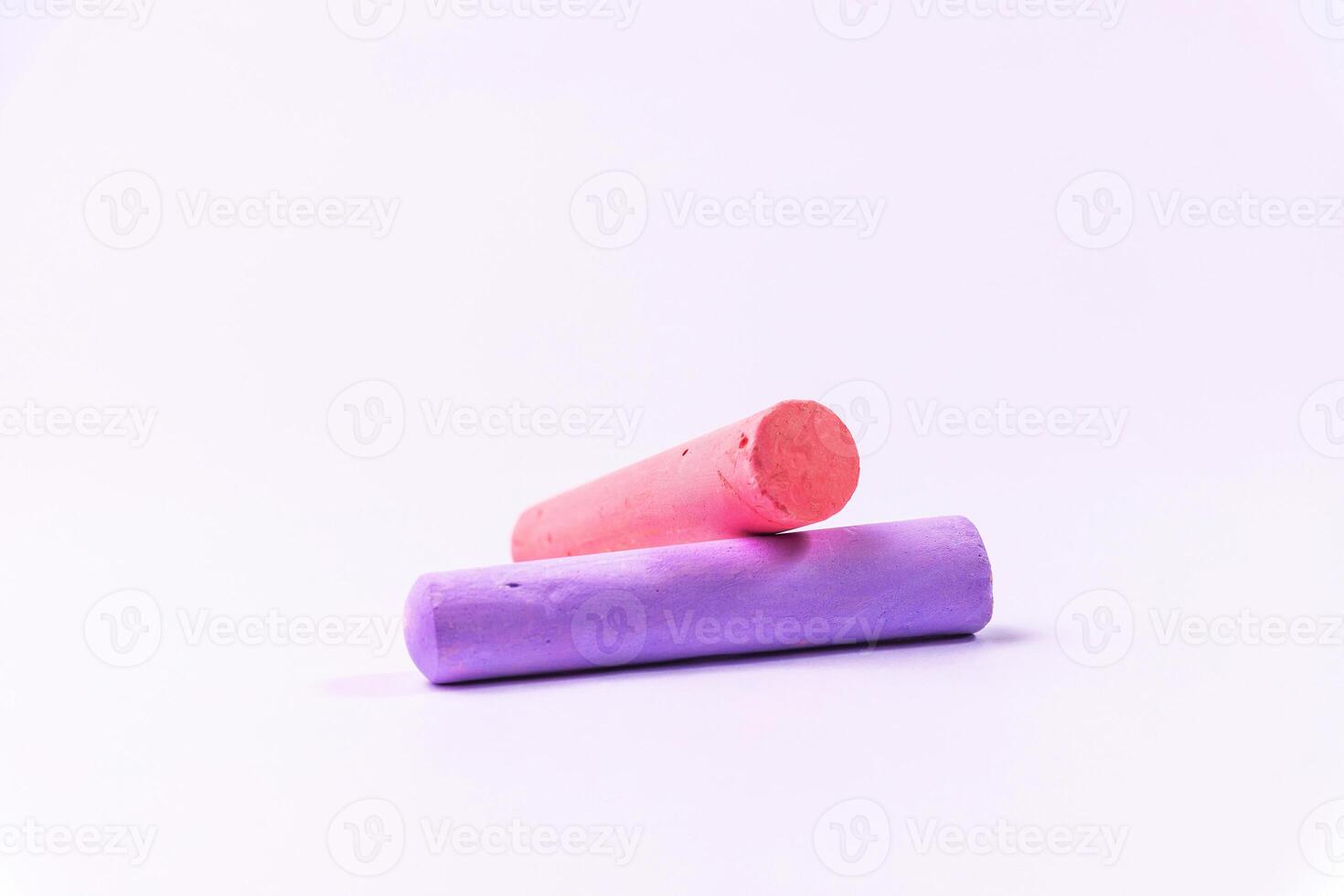 Crayons of different colors arranged on a white background. Education photo