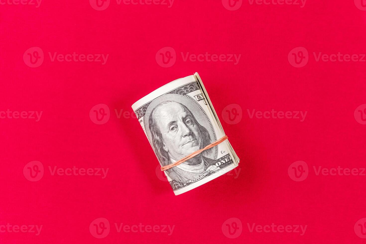 Roll dollars on a red background. Financial concept. photo