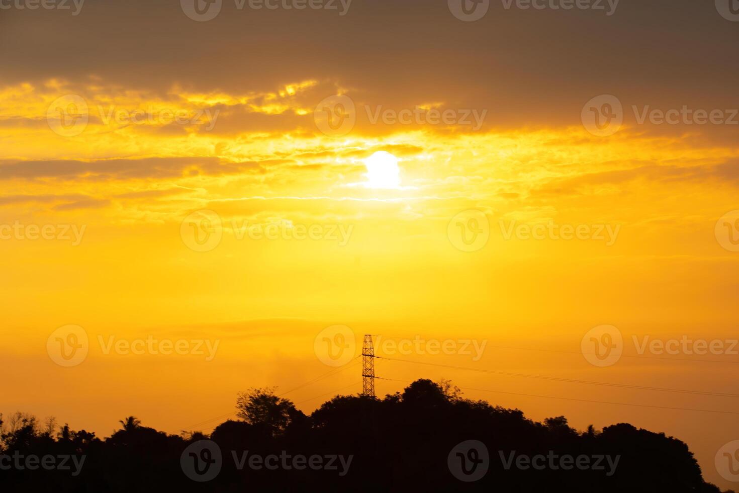 Golden hour, a very amazing sunset between the hills of trees and clouds photo