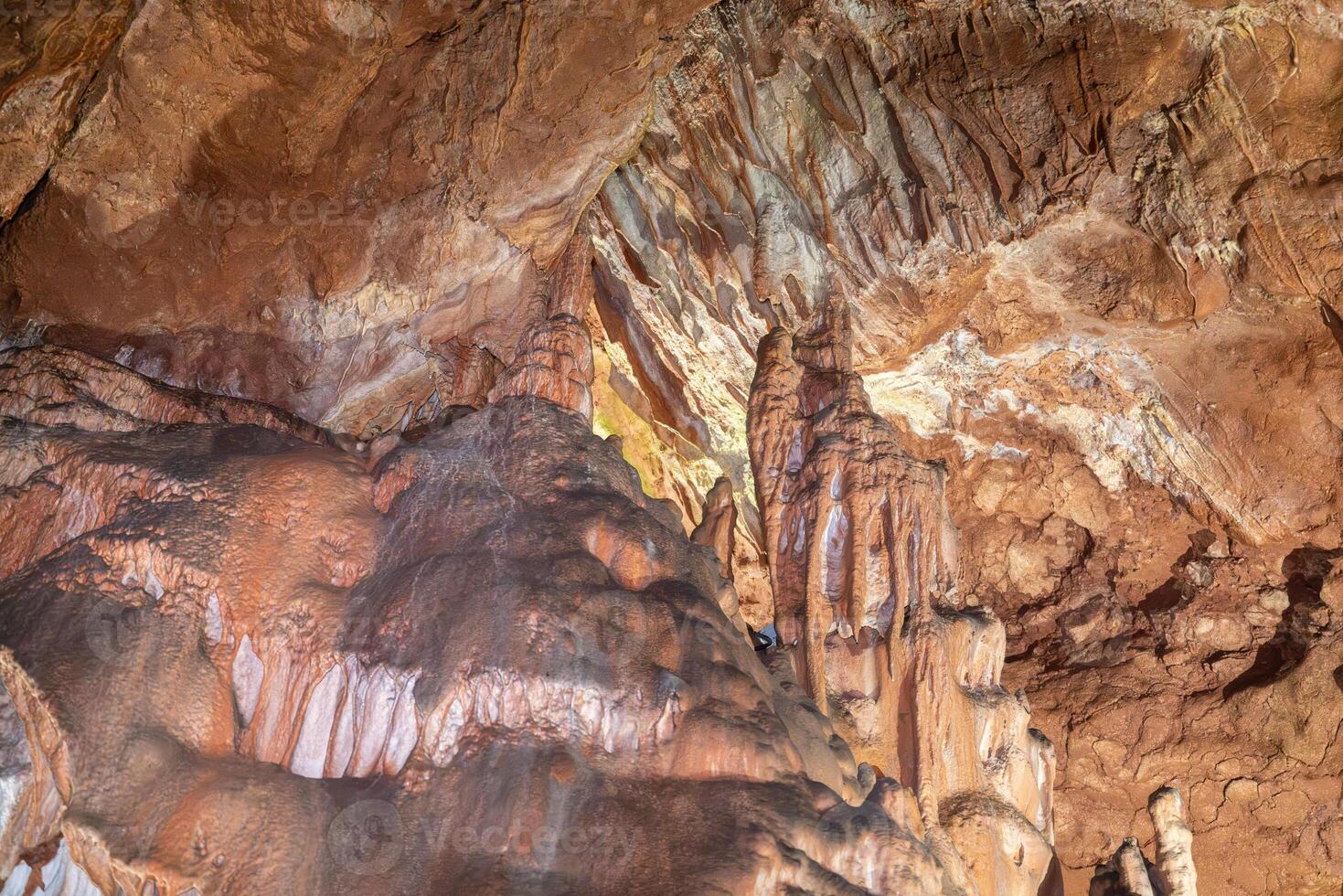 A cave with a lot of rocks and a person in the middle. photo
