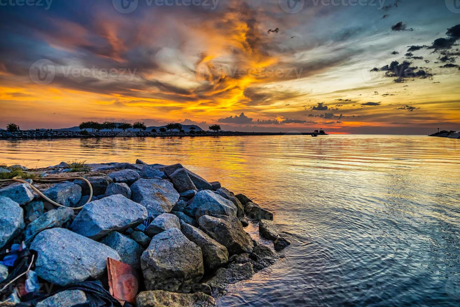 Dramatic Sunset Over a Rocky Seaside, Highlighting the Scenic View of Nature photo