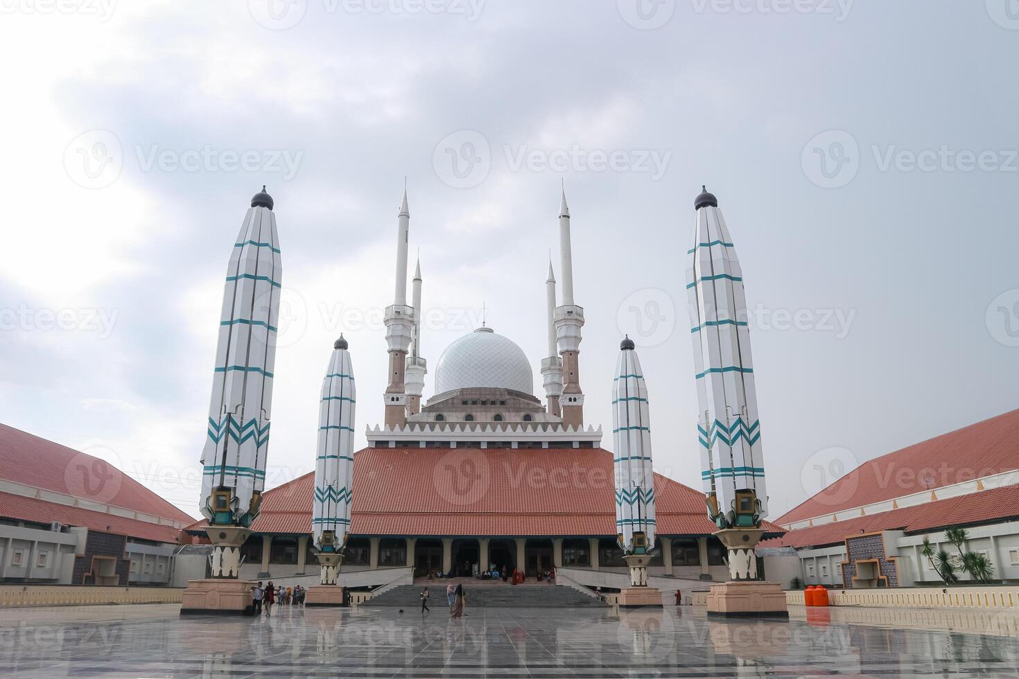 The majestic Great Mosque of Central Java stands tall against a cloudy sky. Its unique architecture and intricate details make it a stunning landmark. photo
