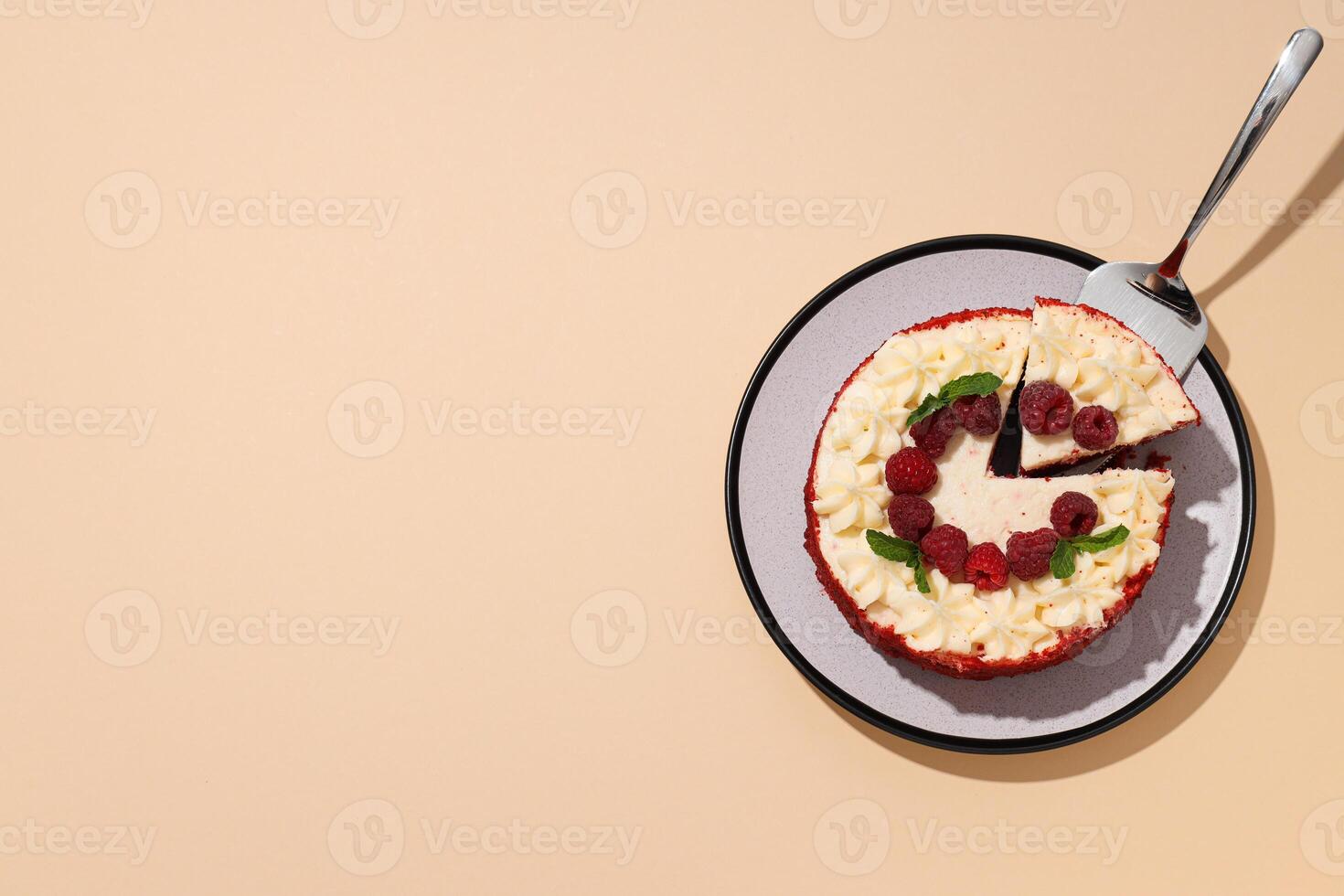Red velvet cake with berries on plate on beige background, space for text photo