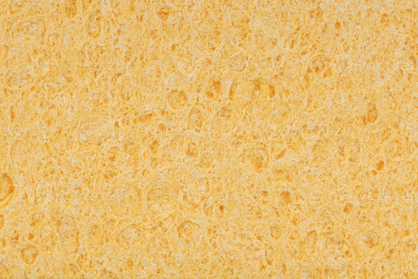 Macro Texture of Yellow Sponge Surface photo
