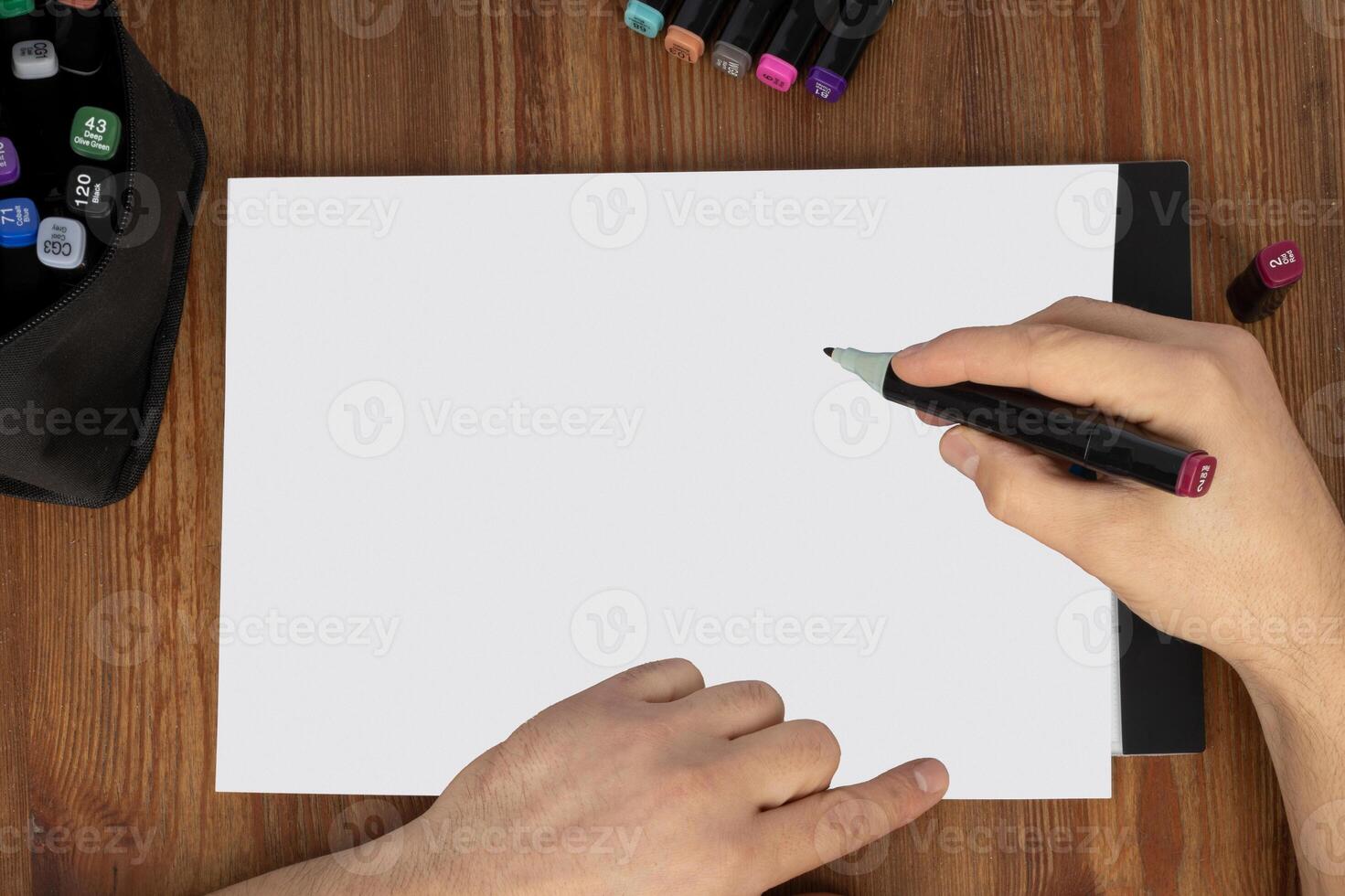 Blank Paper Mockup with Drawing Hand photo