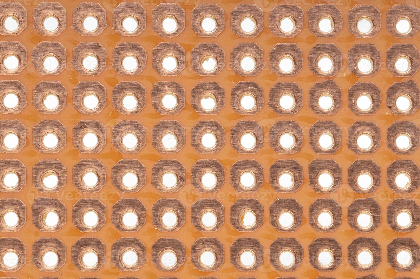 Close up of copper prototyping PCB surface photo