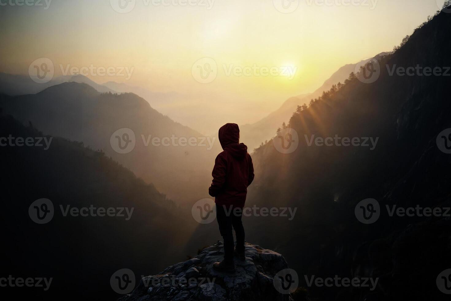 Hiker admiring a stunning mountain landscape at sunrise photo