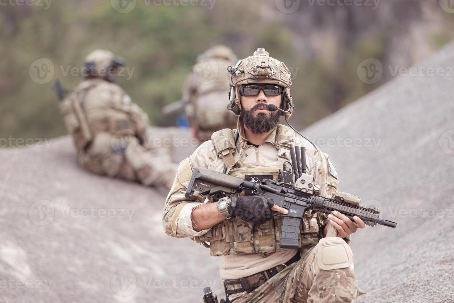 Soldiers in camouflage military uniforms carrying weapons, Reconnaissance missions in rugged mountains, Assault infantry battle training. photo
