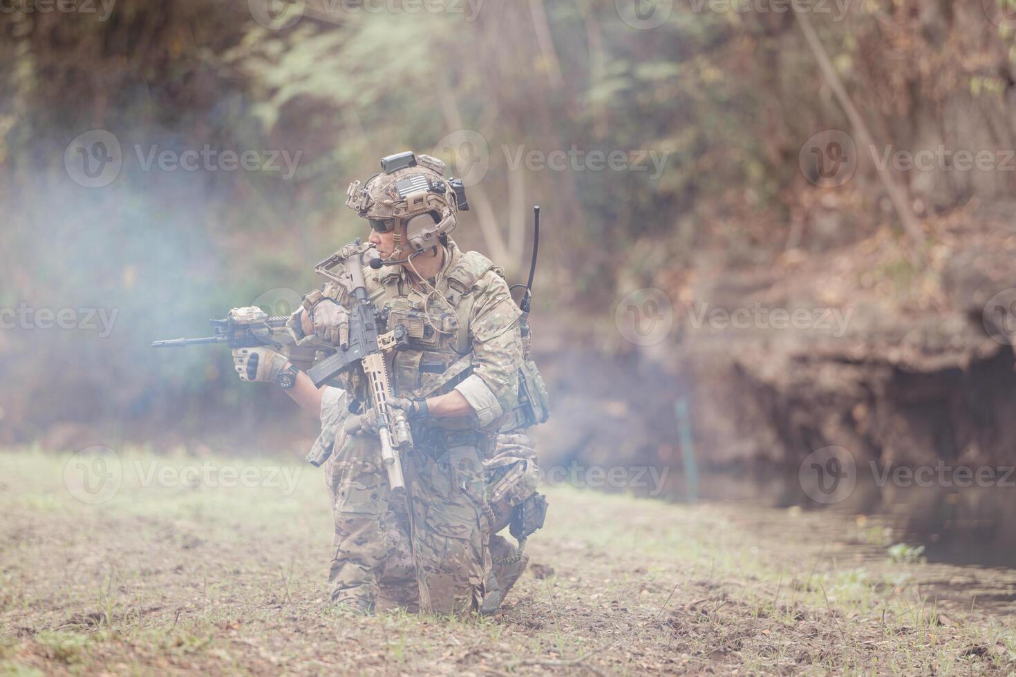 Soldiers in camouflage military uniforms carrying weapons, Reconnaissance missions in the tropical forest area, Assault infantry battle training. photo