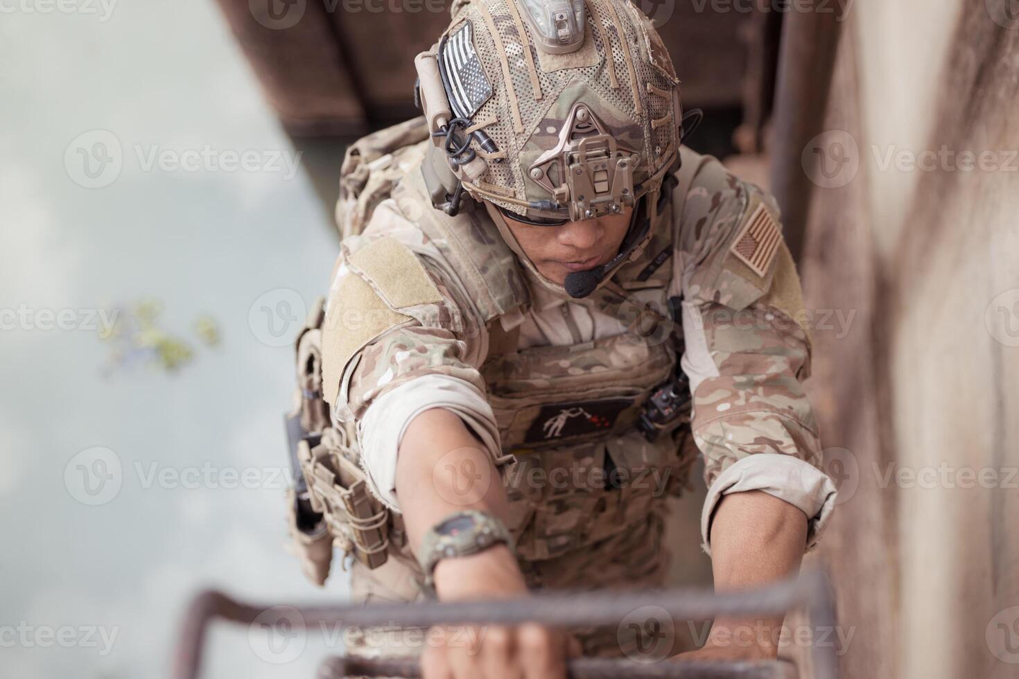 Soldiers in camouflage military uniforms carrying weapons, Reconnaissance missions in the tropical forest area with hiding and camouflaging the enemy photo