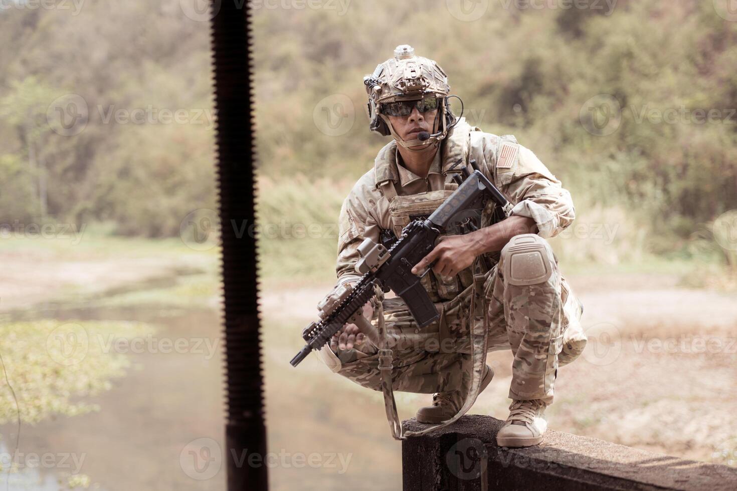 Soldiers in camouflage military uniforms carrying weapons, Reconnaissance missions in the tropical forest area, Assault infantry battle training. photo