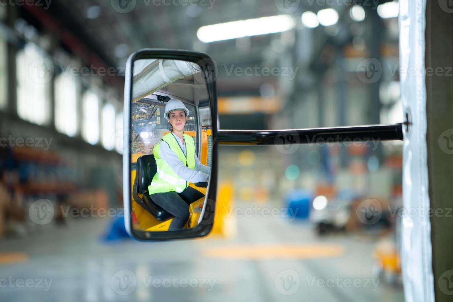Female engineer working in electric train repair shop, Test driving a small grinding the railroad tracks machine before being put out for use. photo