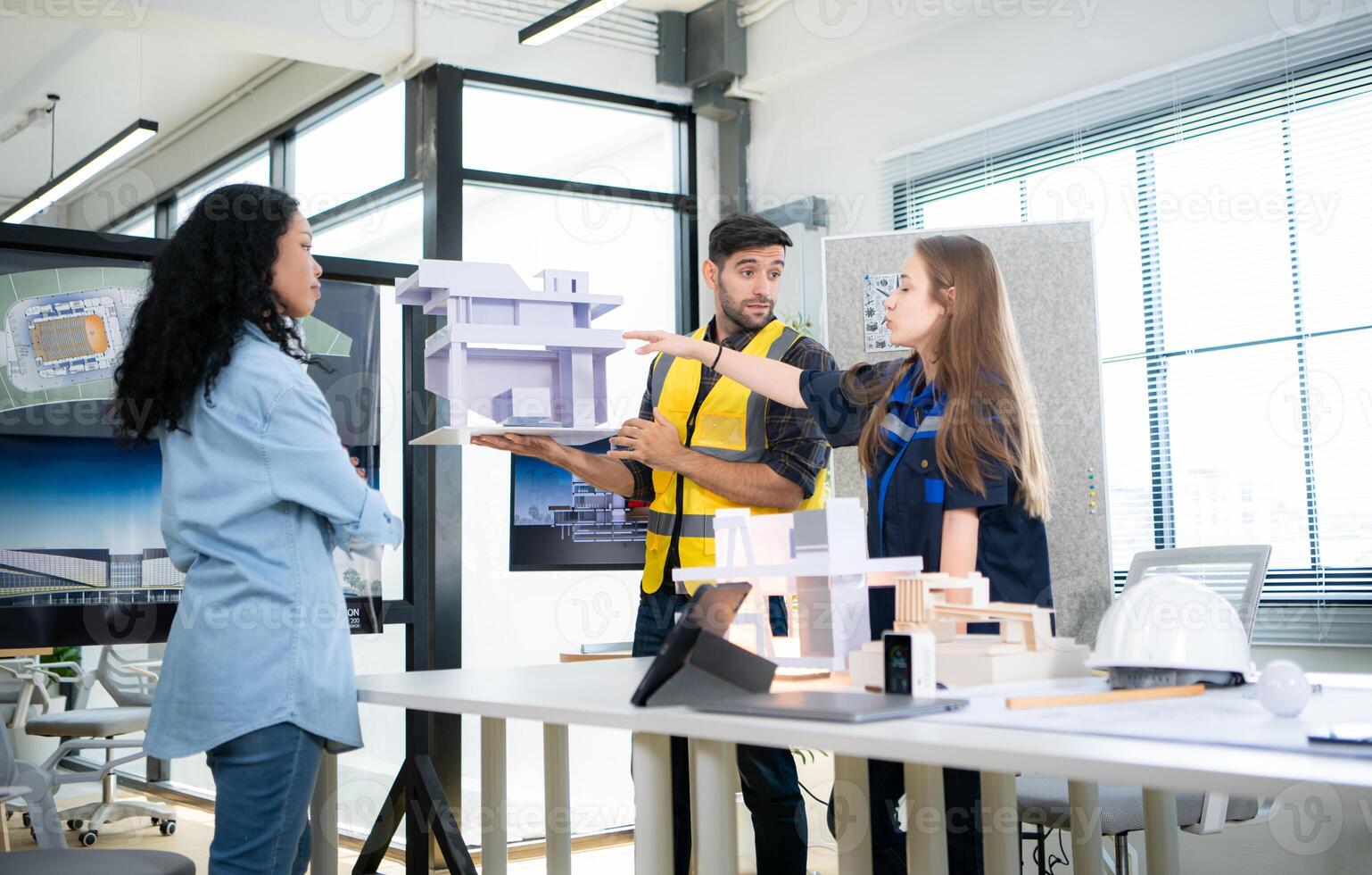 Engineers, architects, and designers collaborate to design a building that employs natural energy. photo