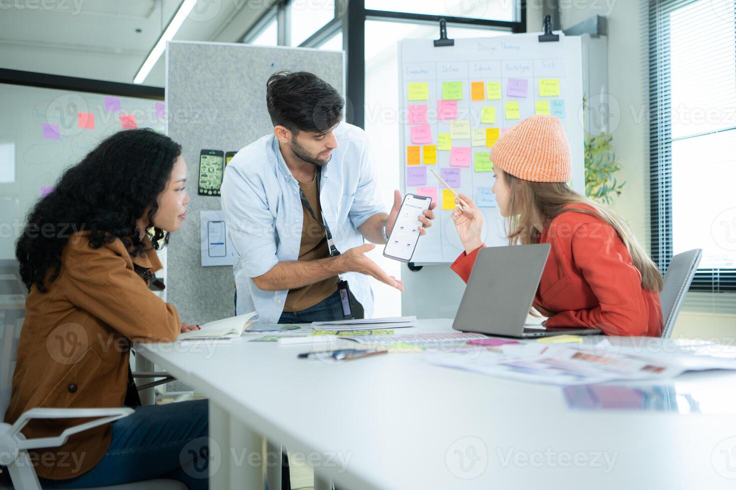 Multiethnic young business people working together in modern office, Collaborate to designing an application for use on the internet network. photo