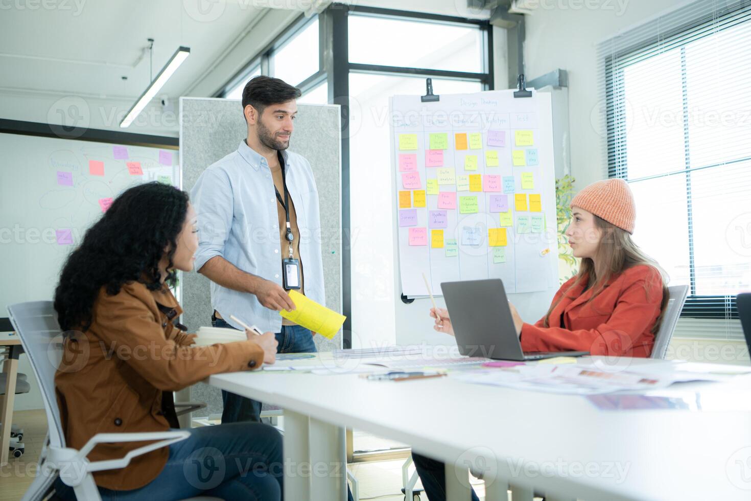 Multiethnic young business people working together in modern office, Collaborate to designing an application for use on the internet network. photo