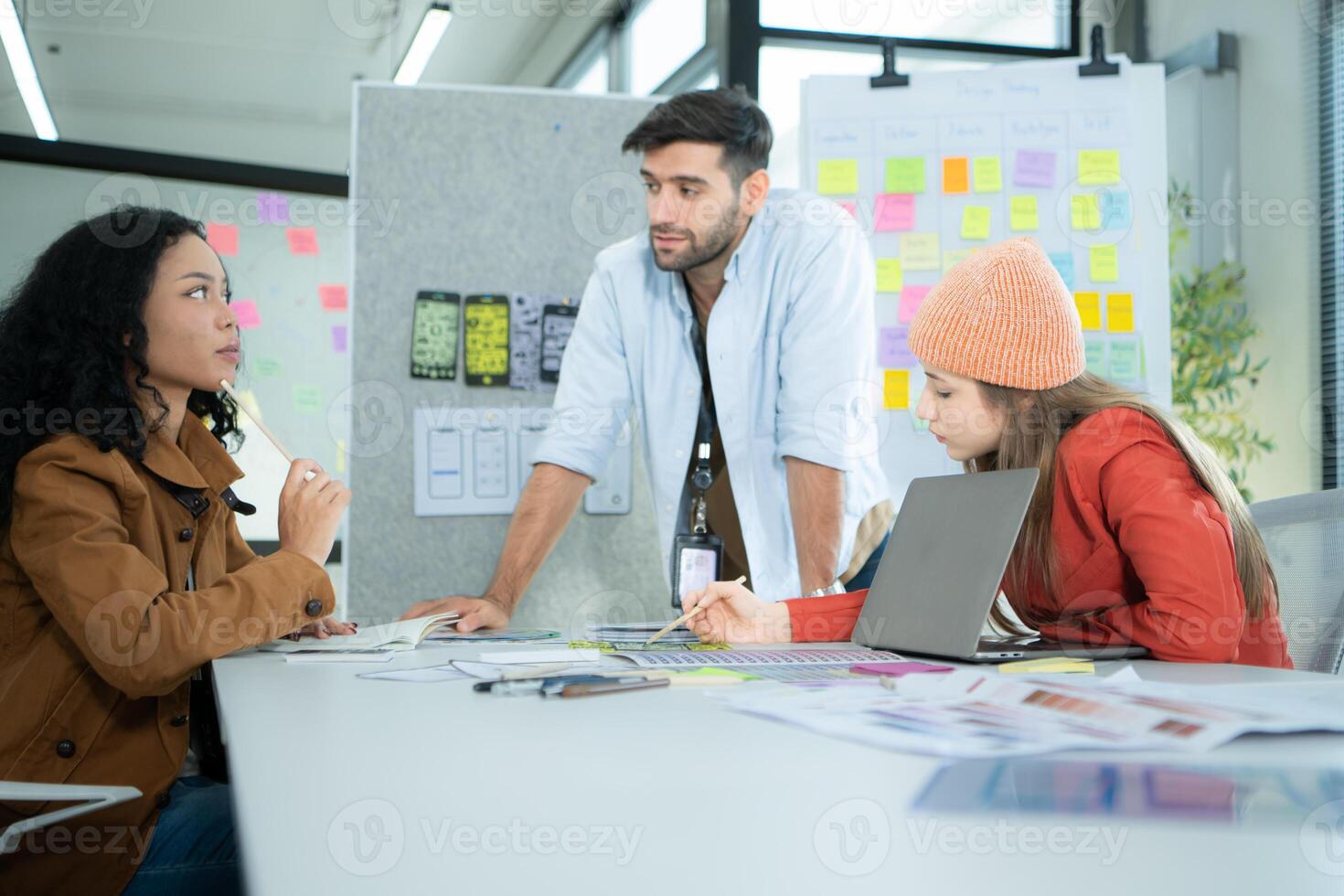 Multiethnic young business people working together in modern office, Collaborate to designing an application for use on the internet network. photo