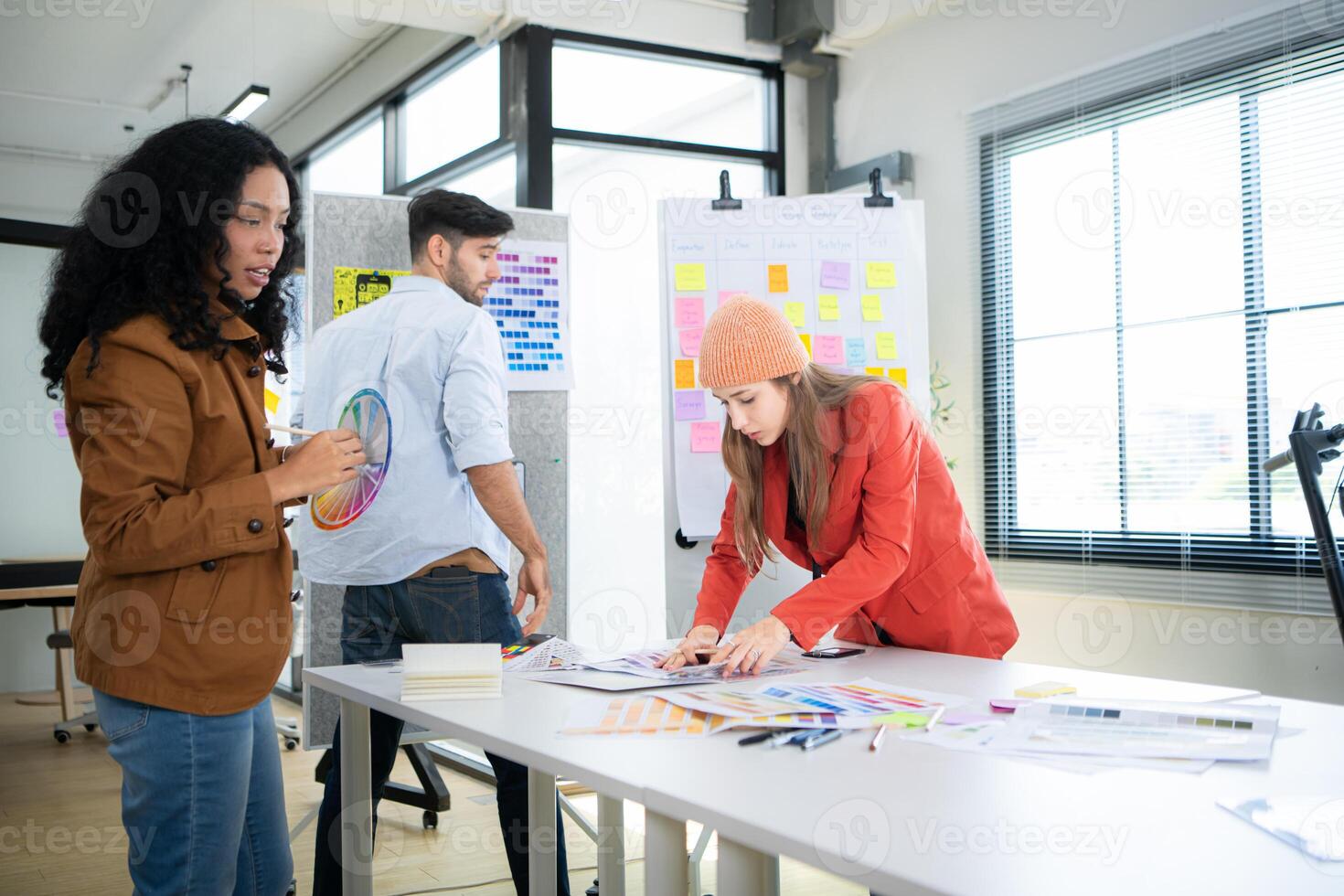 Multiethnic young business people working together in modern office, Collaborate to designing an application for use on the internet network. photo