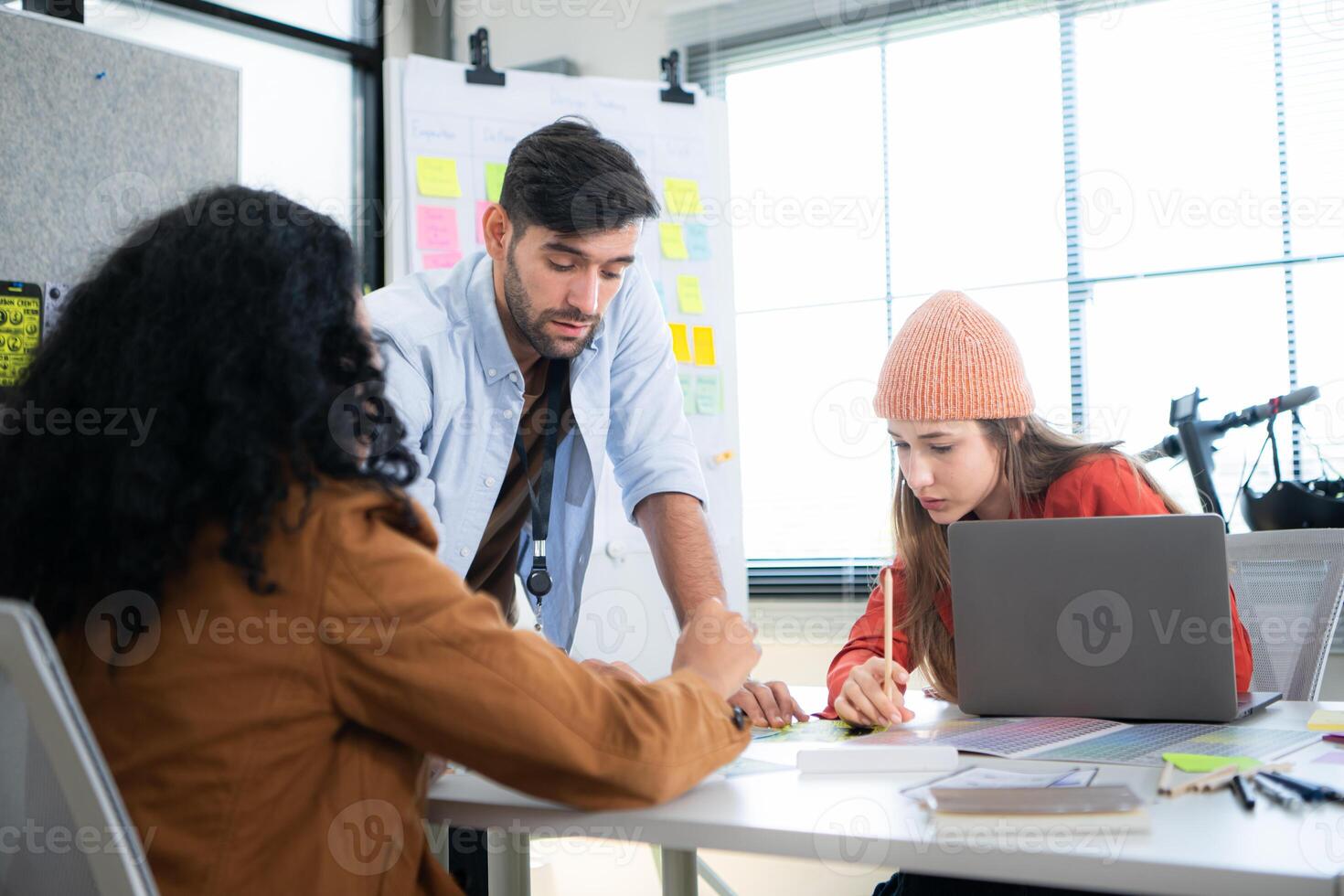 Multiethnic young business people working together in modern office, Collaborate to designing an application for use on the internet network. photo