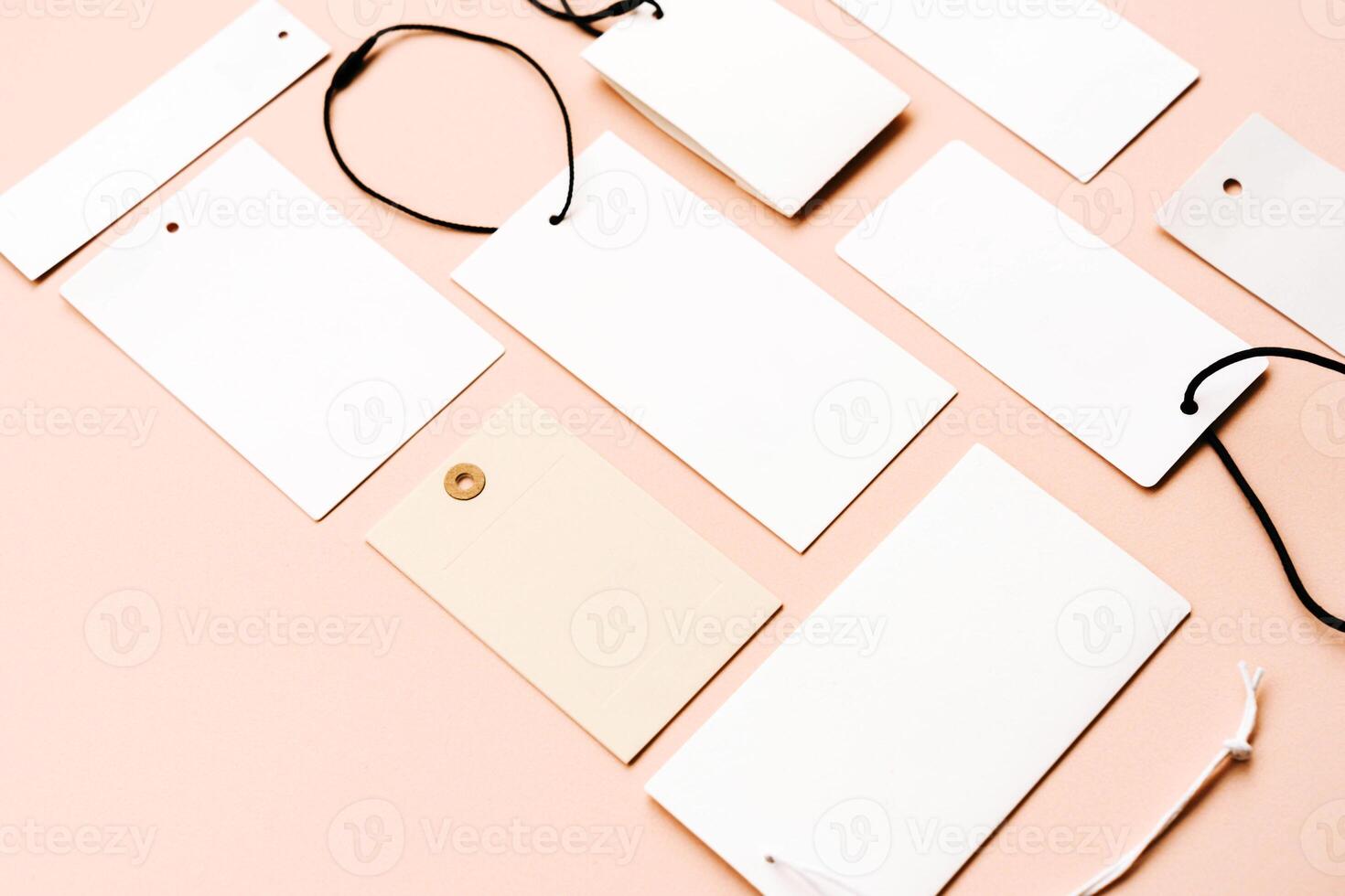 White price labels, blank tags with different shapes and sizes on a beige background. photo