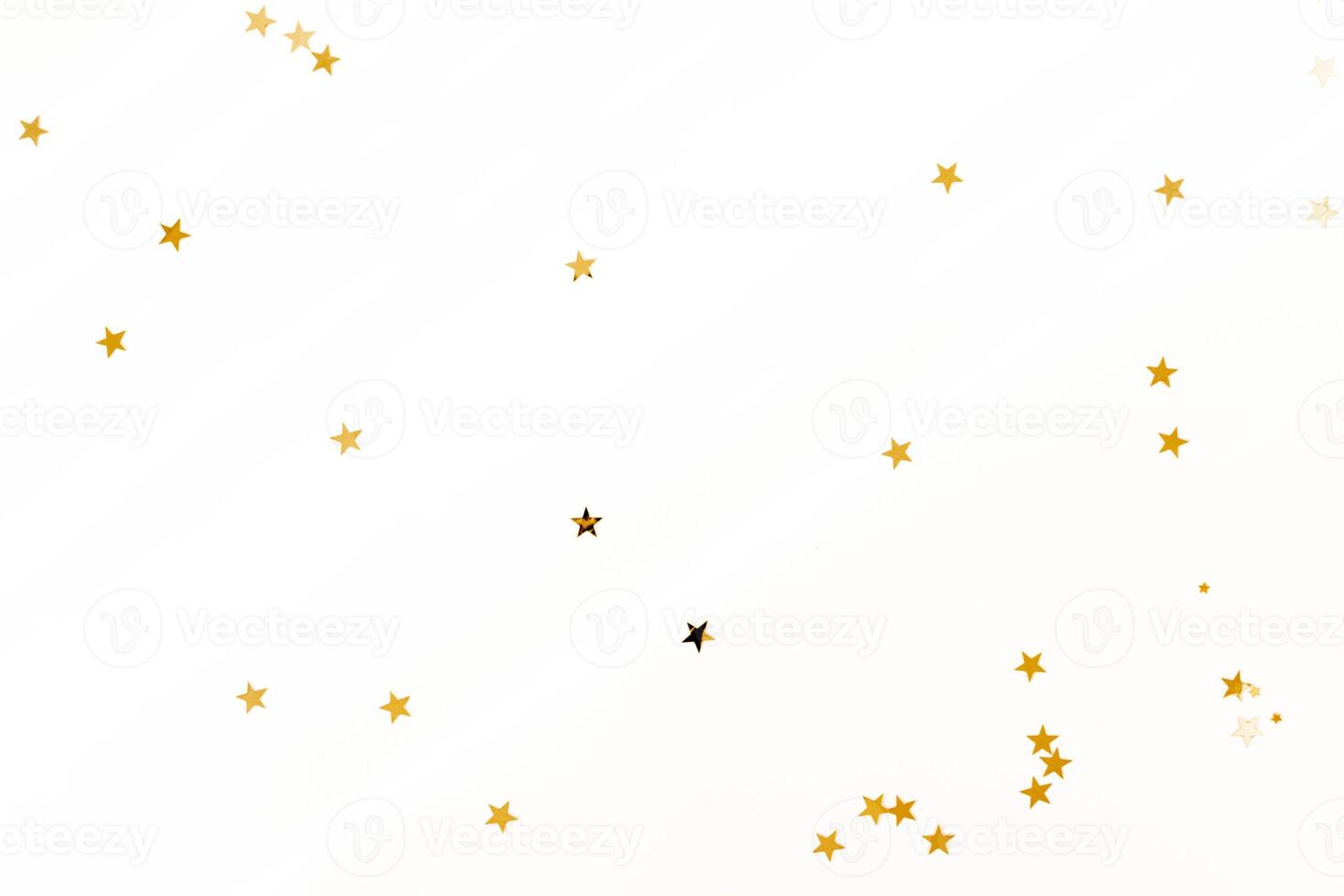 Gold stars on a light pastel background with diagonal shadows. photo