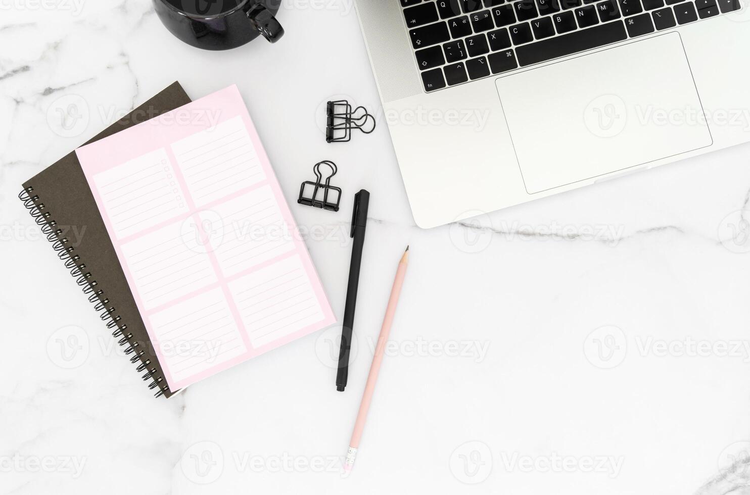 Modern white office desk table with laptop computer, stationery and notepads and cup of coffee. photo