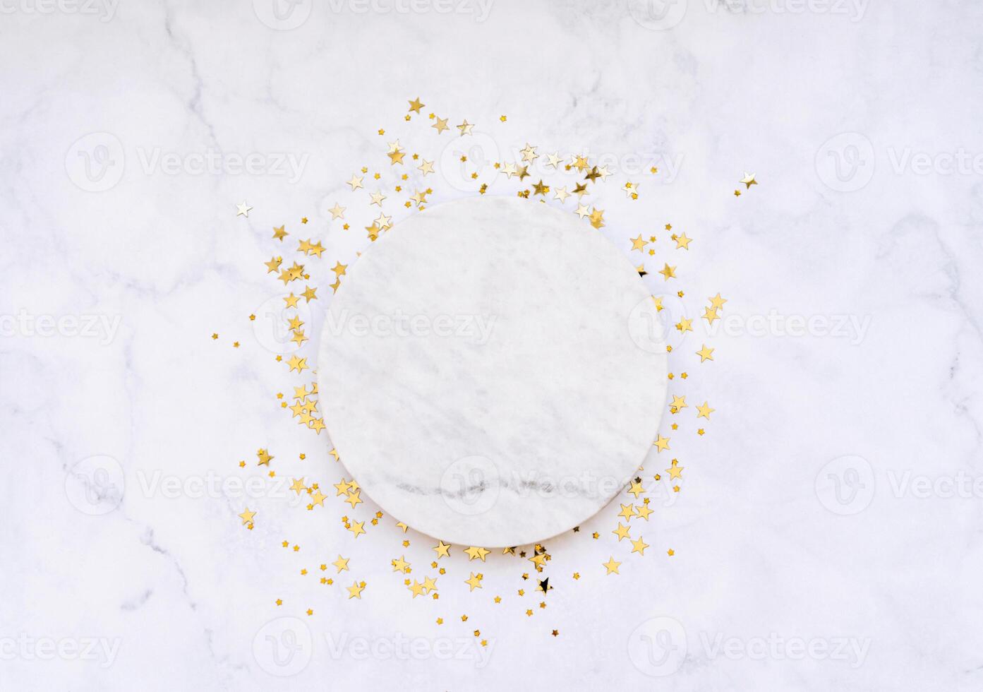 White marble cosmetic podium product design and Christmas golden stars confetti photo