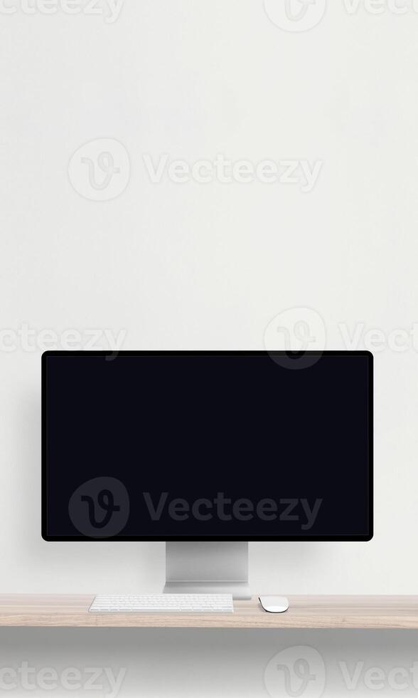 Desktop monitor with a blank screen on a desk featuring a keyboard and mouse, perfect for mockup presentations of websites photo