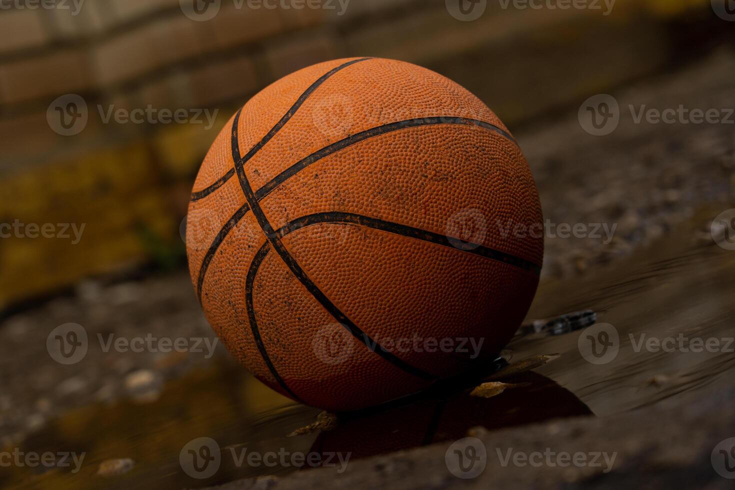 Old Basketball On A Concrete Sidewalk photo