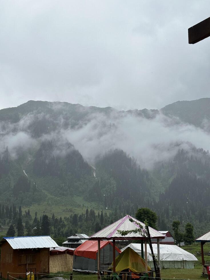 A view of tents and mountains in the background photo