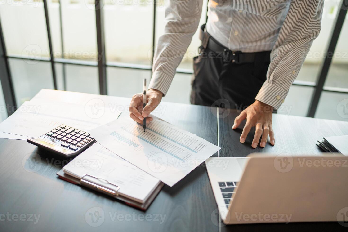 Close up of businessman hands signing or writing document paperwork and report Auditor analysis male professional hand making notes with Business Document. photo
