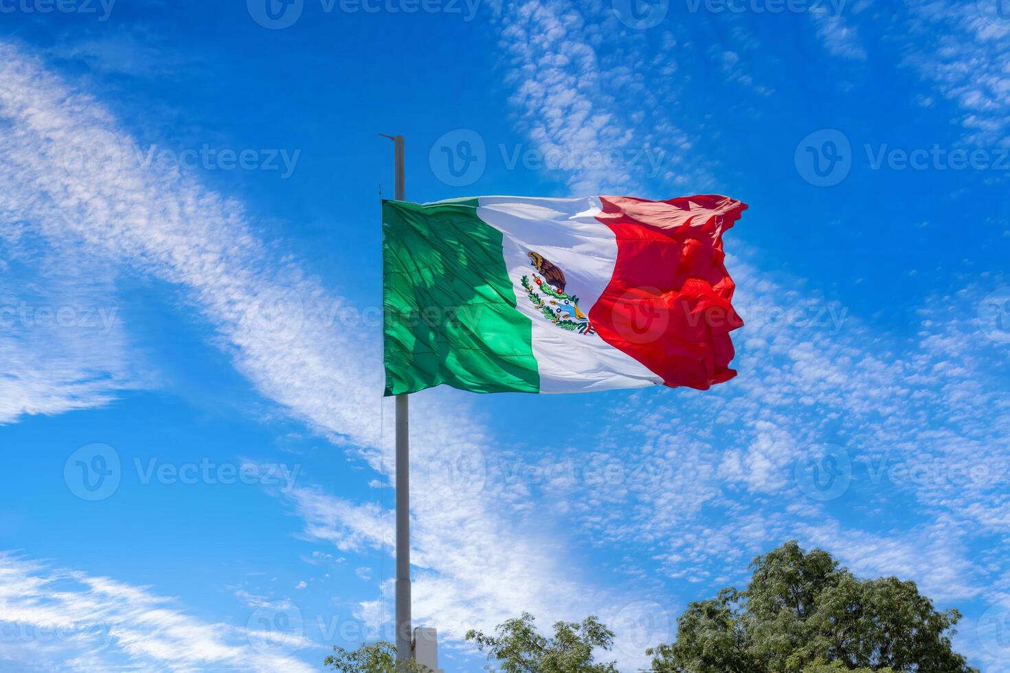 Los Cabos, Mexico, Mexican tricolor national striped flag proudly waving at mast in the air photo