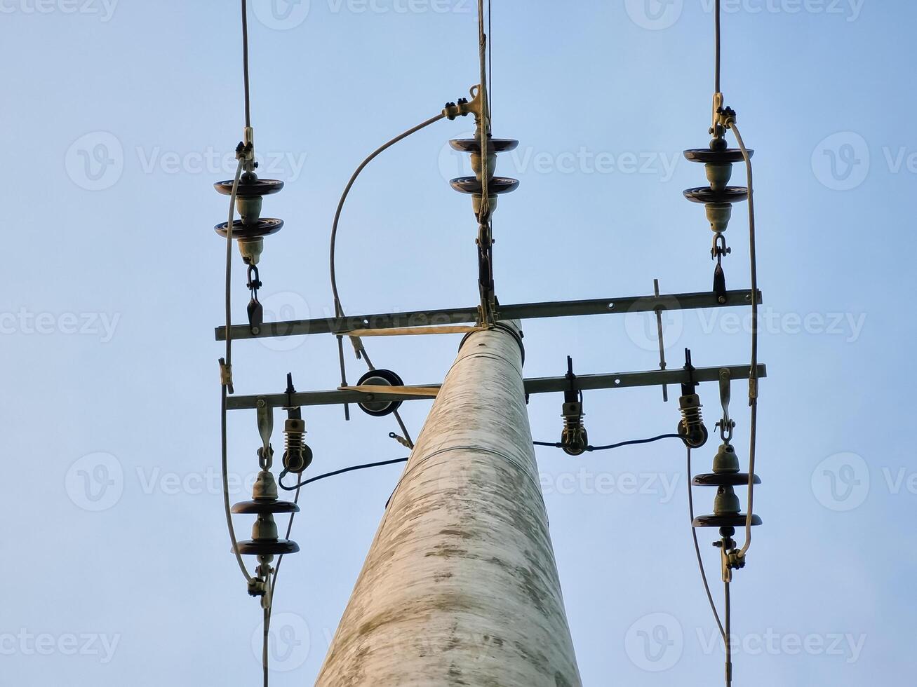 Network of electric cables on power poles with blue sky in the afternoon photo