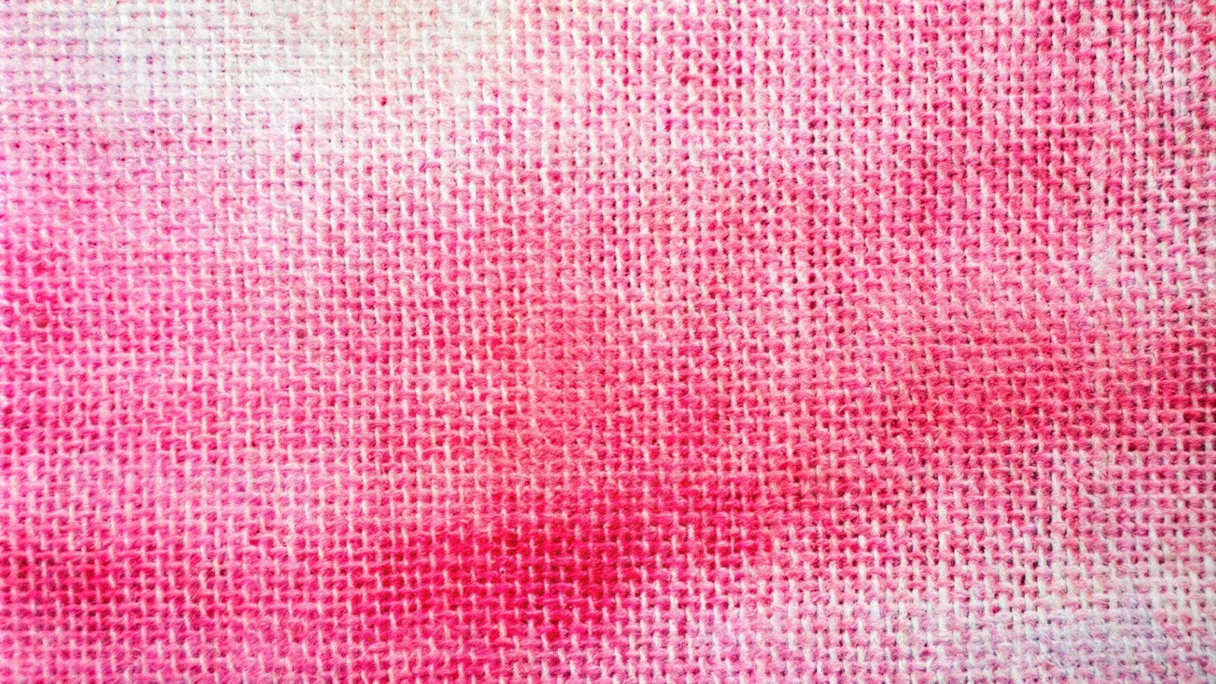 A close up of a pink fabric with white spots photo