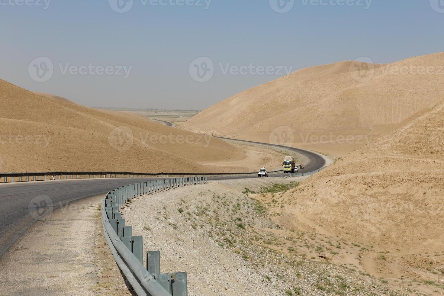 Scenic road winding through arid hills in Faryab Province, Afghanistan photo