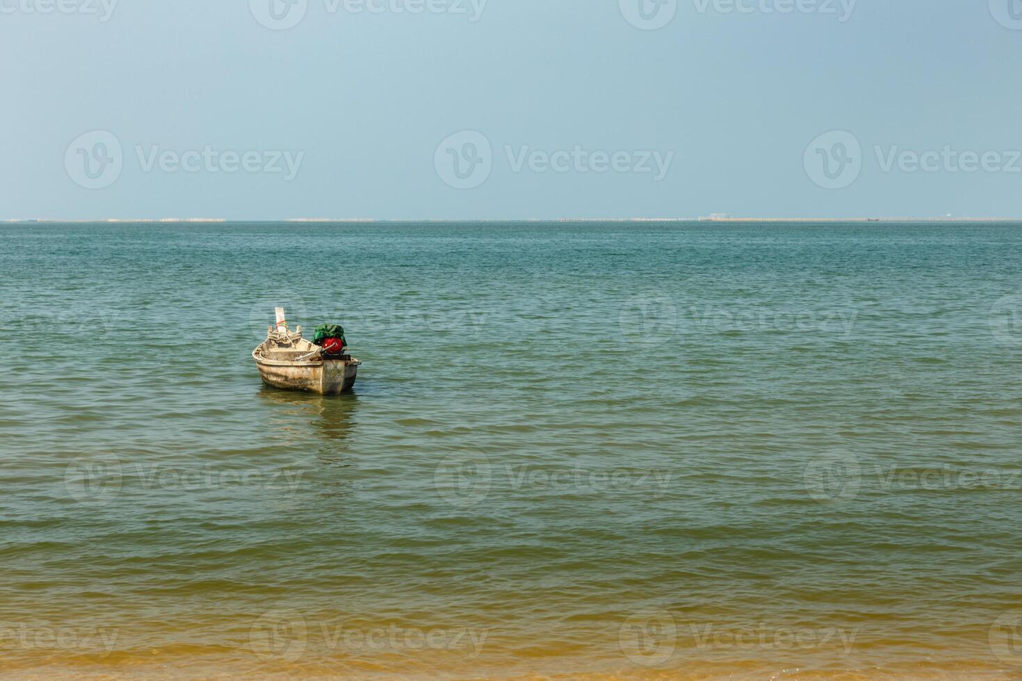 fishing boat in the sea off the coast photo