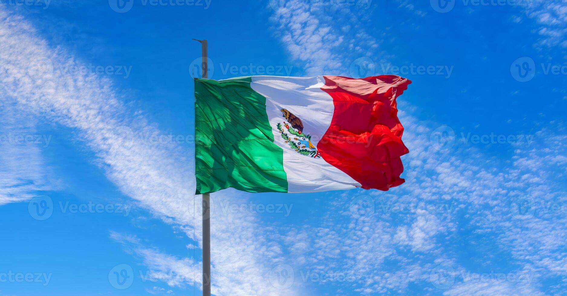 Los Cabos, Mexico, Mexican tricolor national striped flag proudly waving at mast in the air photo