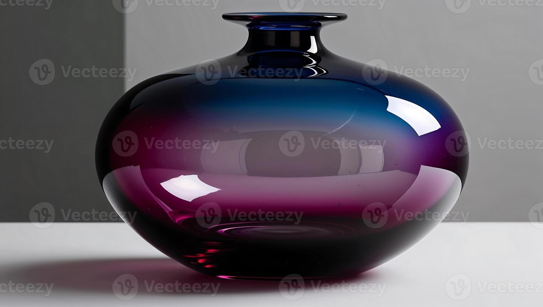 A purple and blue glass vase sitting on a table photo