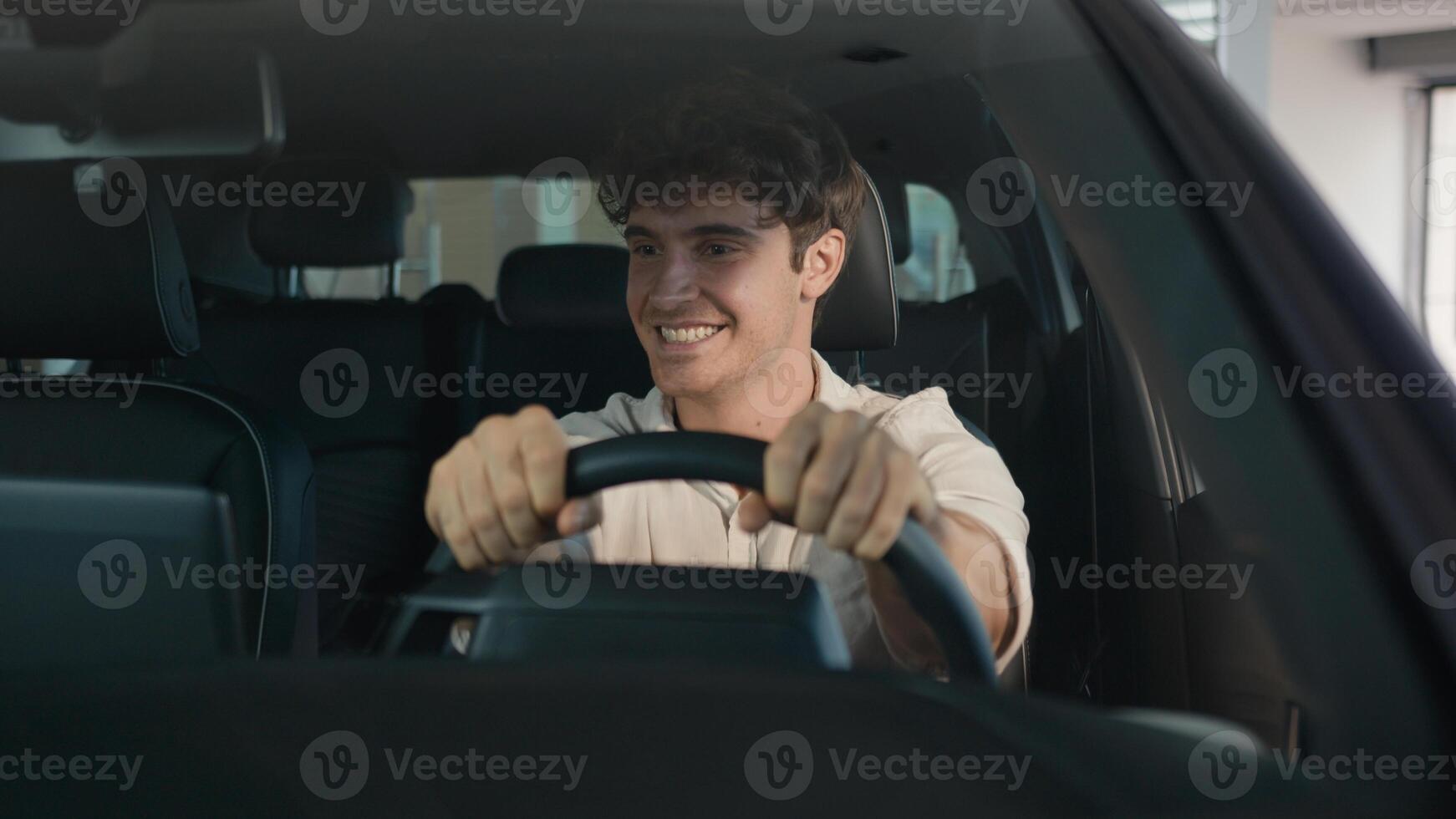 Caucasian happy carefree cheerful man buyer owner of new car guy successful businessman sitting inside automobile celebrate auto transport vehicle buying purchase dancing enjoy music at radio achieve photo