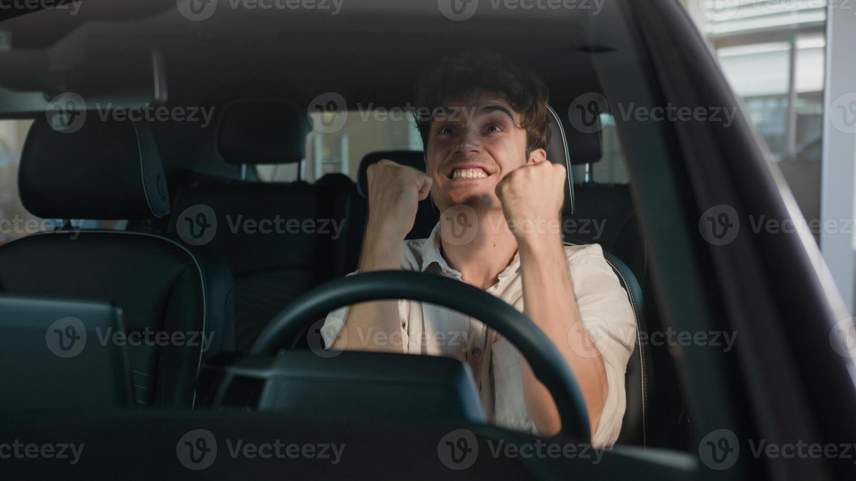 Happy Caucasian successful business joyful man sit in new car in automobile shop rent service dealership celebrate purchase of luxury modern buy vehicle businessman male emotions of happiness driving photo